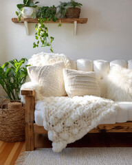 Cozy Living Room with Soft White Sofa and Decorative Pillows Surrounded by Indoor Plants
