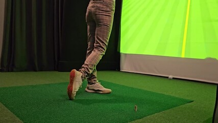 Indoor golf practice session with swing analysis at virtual simulator