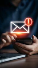 Glowing envelope notification with exclamation mark above hands holding smartphone email alert