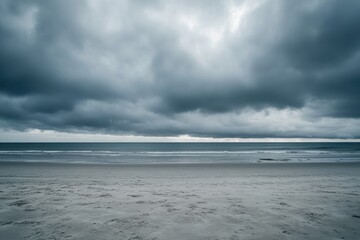 Fototapeta premium Stormy beach scene. Vast grey clouds loom over a tranquil beach. Soft waves gently lap at the shore. A muted palette of greys and blues