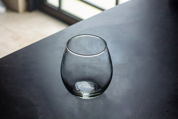 Elegant Clear Empty Glass Cup on a Dark Modern Table Surface