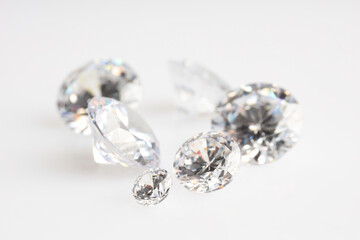 Many shiny diamonds on light background, closeup