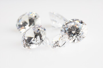 Many shiny diamonds on light background, closeup