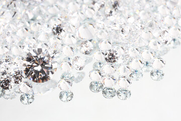 Many shiny diamonds on light background, closeup