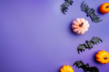 A modern greeting card for Halloween. Pumpkins, cobwebs, spiders, bats, a ghost on a fashionable...