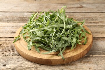 Fresh ripe green arugula leaves on wooden table, closeup