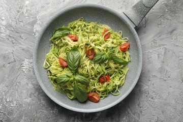 Tasty zucchini noodles with tomatoes and basil, top view