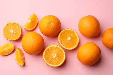 Fresh ripe oranges on pink background, flat lay