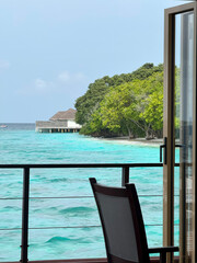Seaside view from tropical resort balcony overlooking turquoise ocean — relaxation and...