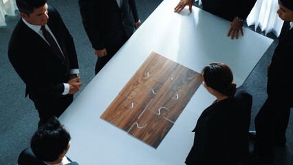 Top view of business people putting jigsaw together at meeting room. Professional marketing team...