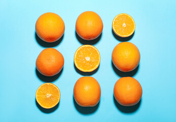 Fresh ripe oranges on light blue background, flat lay