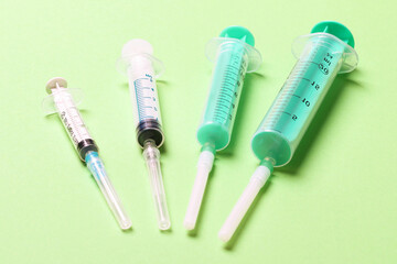 Top view of different syringes for injection on colorful background. Medical equipment concept with...