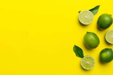 Lime fruits with green leaf and cut in half slice isolated on white background. Top view. Flat lay...