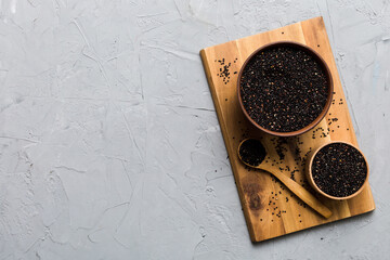 quinoa seeds in bowl and spoon on colored background. Healthy kinwa in small bowl. Healthy superfood