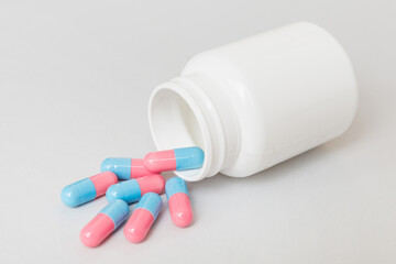 different drugs and health supplement pills poured from a medicine bottle health care and medical...