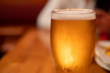 Close up of beer in a glass with blur background