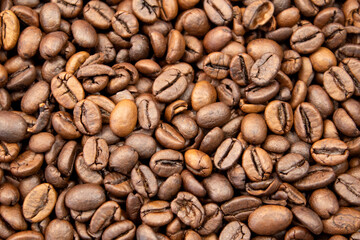 Photo of Big pile of fresh roasted coffee beans close up. Food photo