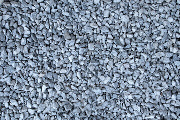 Gray small rocks ground texture. black small road stone background