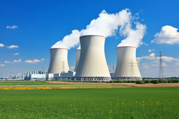 Nuclear power plant with cooling towers emitting steam