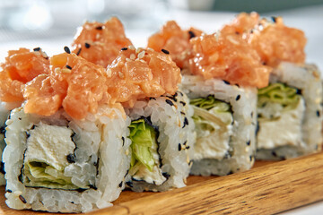A Delicious Platter of Fresh Sushi Rolls Topped with Savory Salmon and Crunchy Vegetables Perfect for Culinary Indulgence and Gastronomic Delight