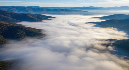 Obraz premium Misty Valley: Aerial View of Mountains Enshrouded in Dense Morning Fog