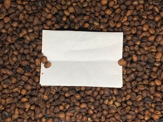 White texture paper on coffee beans frame