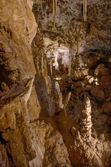 Karst formations inside Punkva Cave with illuminated stalactites and stalagmites, Moravian Karst, Czech Republic.