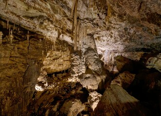 Karst formations inside Punkva Cave with illuminated stalactites and stalagmites, Moravian Karst, Czech Republic.