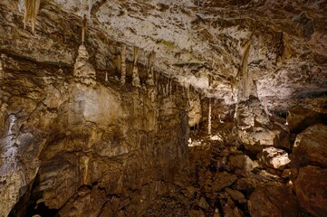 Karst formations inside Punkva Cave with illuminated stalactites and stalagmites, Moravian Karst, Czech Republic.