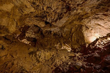 Karst formations inside Punkva Cave with illuminated stalactites and stalagmites, Moravian Karst, Czech Republic.