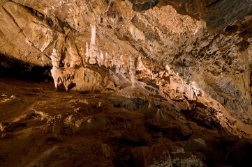 Karst formations inside Punkva Cave with illuminated stalactites and stalagmites, Moravian Karst, Czech Republic.