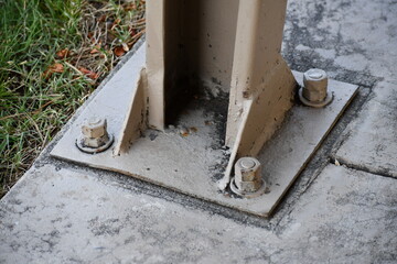 Thin steel baseplate on outdoor picnic structure.
