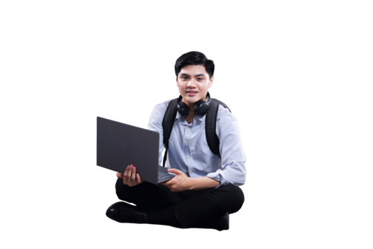 Young man with Laptop: A young man wearing a casual button-down shirt, backpack, and headphones sits cross-legged with an open laptop on his lap. - Powered by Adobe