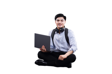 Young Professional At Work: A focused young professional, sitting cross-legged, seamlessly integrates technology into their daily routine, a symbol of the modern work-life blend.
