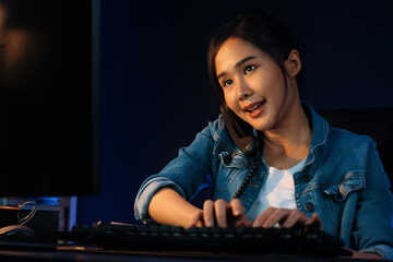 Young beautiful Asian creative woman calling on phone desk to customer or coworker explaining...