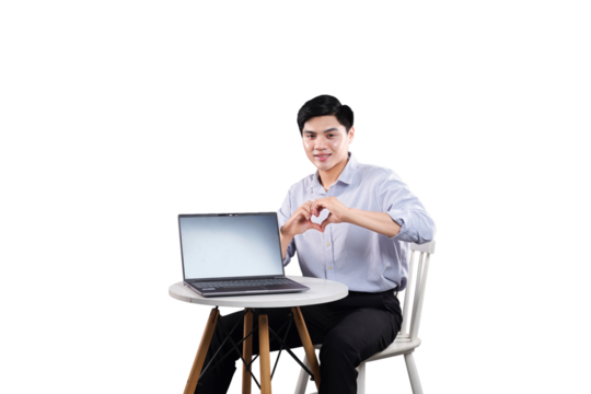 Laptop love: A modern professional sits, expressing affection towards the laptop with a heart-shaped hand gesture. It's a showcase of technological ease.