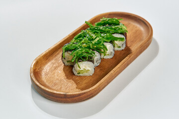 A Delicious Serving of Sushi Crafted with Fresh Ingredients, Featuring Rice Rolls Topped with...