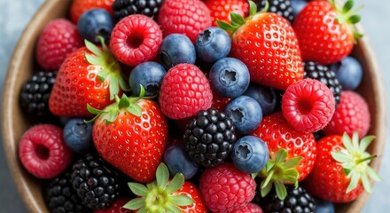 Vibrant mixed berries: Strawberries, raspberries, blueberries, and blackberries in a close-up, colorful display