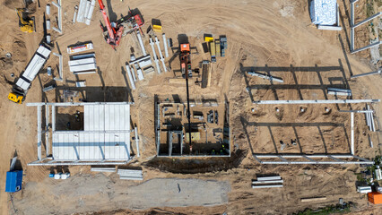 Aerial View of Active Construction Site with Cranes and Workers