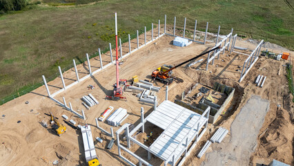 Aerial View of Construction Site with Cranes and Steel Beams
