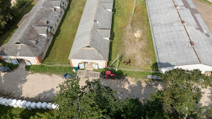 Aerial View of Farm with Barns and Tractor
