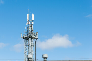 mast with antennas against the blue sky