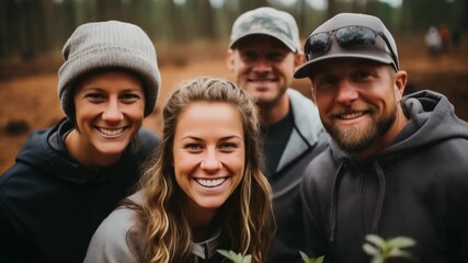 Friends gather in a forest to plant young trees as part of a community conservation effort. They show joy and teamwork while contributing to environmental health
