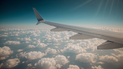 Obraz premium The wing of an airplane stretches through the soft clouds, capturing a breathtaking moment above the earth, where sky and metal meet in a serene and dreamy high-altitude view
