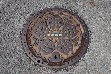manhole cover in a street in tokyo in japan 