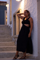 portrait of young woman in a black dress looking at camera	