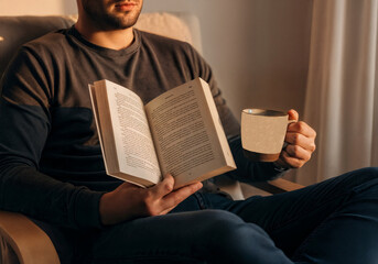 Relaxed Man Reading Book With Tea in Cozy Sunset Light