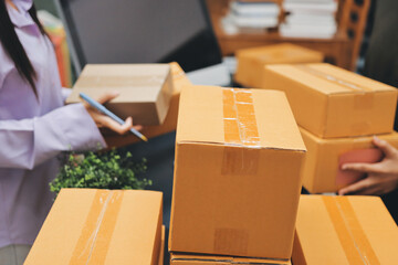Portrait of Starting small businesses SME owners, two Asian woman check online orders Selling...
