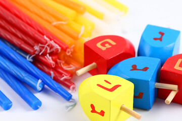 Hanukkah Candles and dreidels, isolated over white background