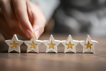Five star customer review, hand placing wooden stars, concept of feedback and satisfaction